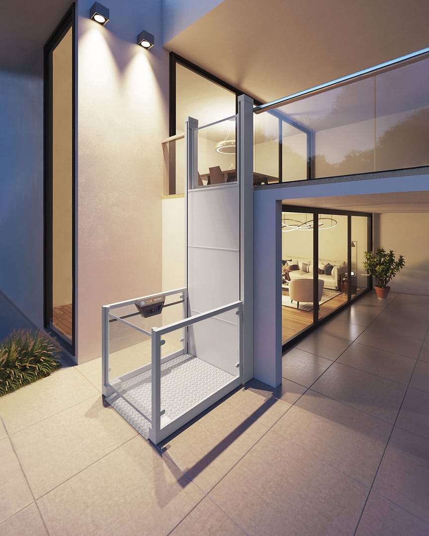 Ascendor_UP 1 Exterior view of a modern home with a small wheelchair lift at the entry beside glass doors; warm interior lighting visible inside.